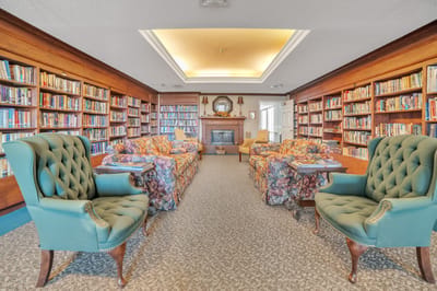 A cozy library area with comfortable seating and bookshelves