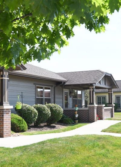 Exterior view of a senior living facility with landscaping