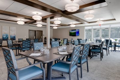 Dining room with tables and chairs set up for residents