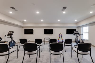 Activity room with exercise equipment and seating