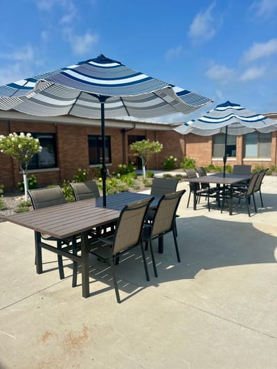 Outdoor dining area with shaded tables and chairs
