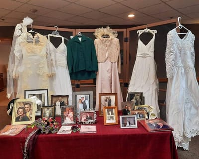 Display of wedding dresses and photographs at an event