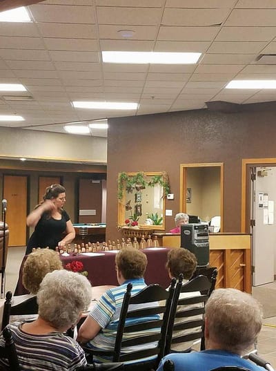 Residents participating in a bell choir activity in a common area