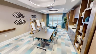 Bright and modern activity room with tables and easels
