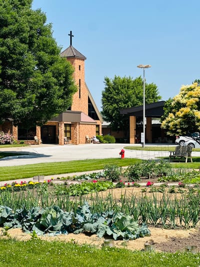 Exterior view of Pleasantview Assisted Living with gardens