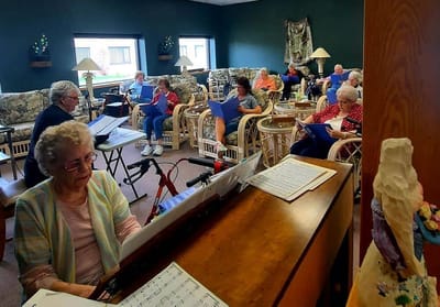 Residents participating in a music activity in a lounge area