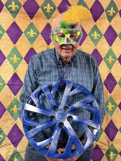Resident celebrating with festive mask and wheel hub