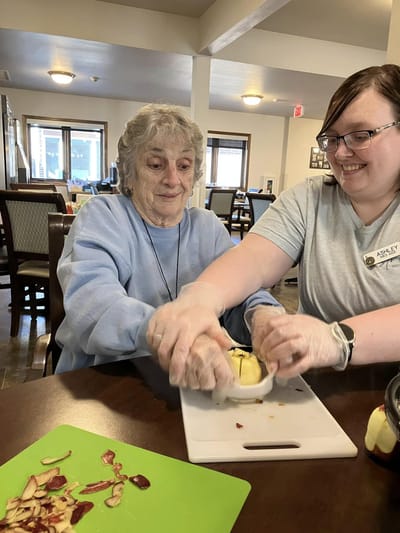 Residents and staff engaged in an activity in the facility