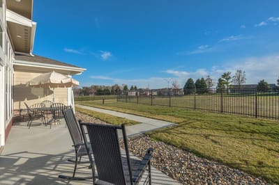 Outdoor patio area with seating and fence
