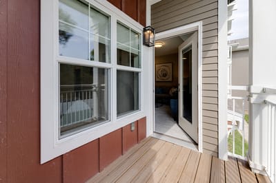 View of an entrance with open door and balcony