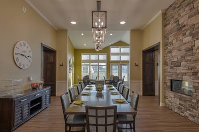 Dining area with long table and modern decor
