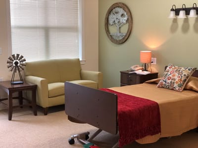 Cozy resident room with a bed and seating area