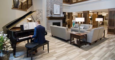 Piano player performing in a welcoming common area