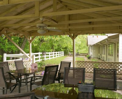 Outdoor patio area with seating and greenery