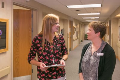 Staff members talking in a hallway