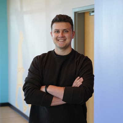 Smiling staff member in a well-lit hallway