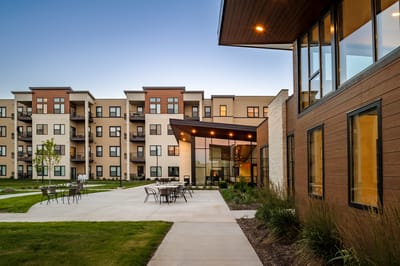 Exterior view of a senior living facility with a patio