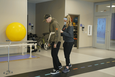 Therapist assisting a resident in an activity room