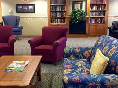 Cozy common area with seating and bookshelves