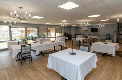 Bright dining room with tables set for meals