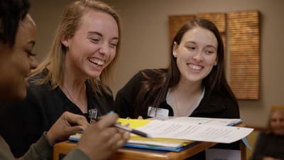Staff members smiling and engaging at a communal area