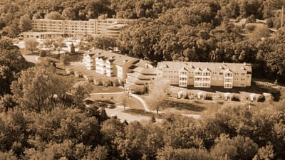 Aerial view of Meth Wick Health Center campus surrounded by trees