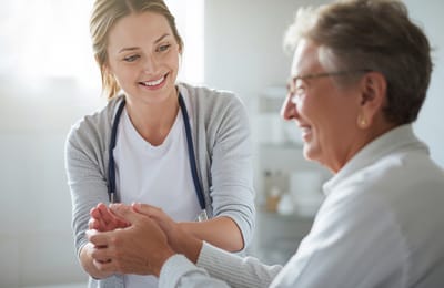 Staff member interacting with a resident in a warm setting