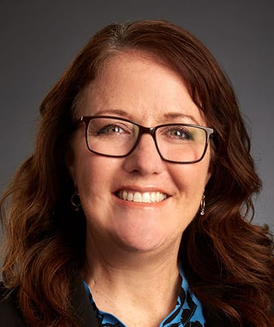 Smiling woman with glasses in a professional setting