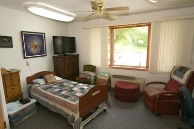 Cozy private resident room with bedding and furniture