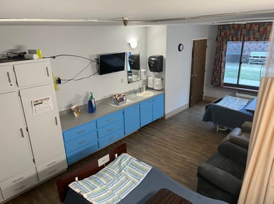 Private resident room with two beds and bathroom area