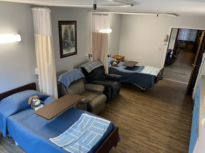 Cozy resident room with two beds and a recliner