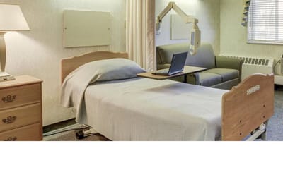 Well-furnished private resident room with bed and seating area