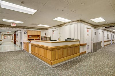 Lobby area of a senior care facility with reception desk