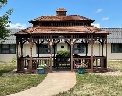 Wooden gazebo in a grassy outdoor space