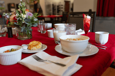 A beautifully set dining table with food and drinks