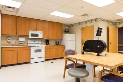 Bright activity room with kitchen amenities