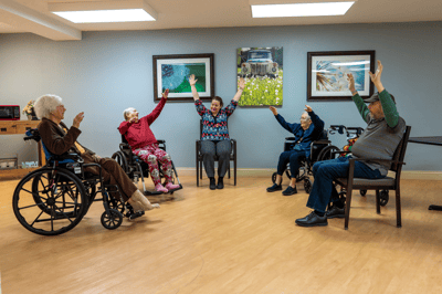 Residents participating in a seated activity in a common area