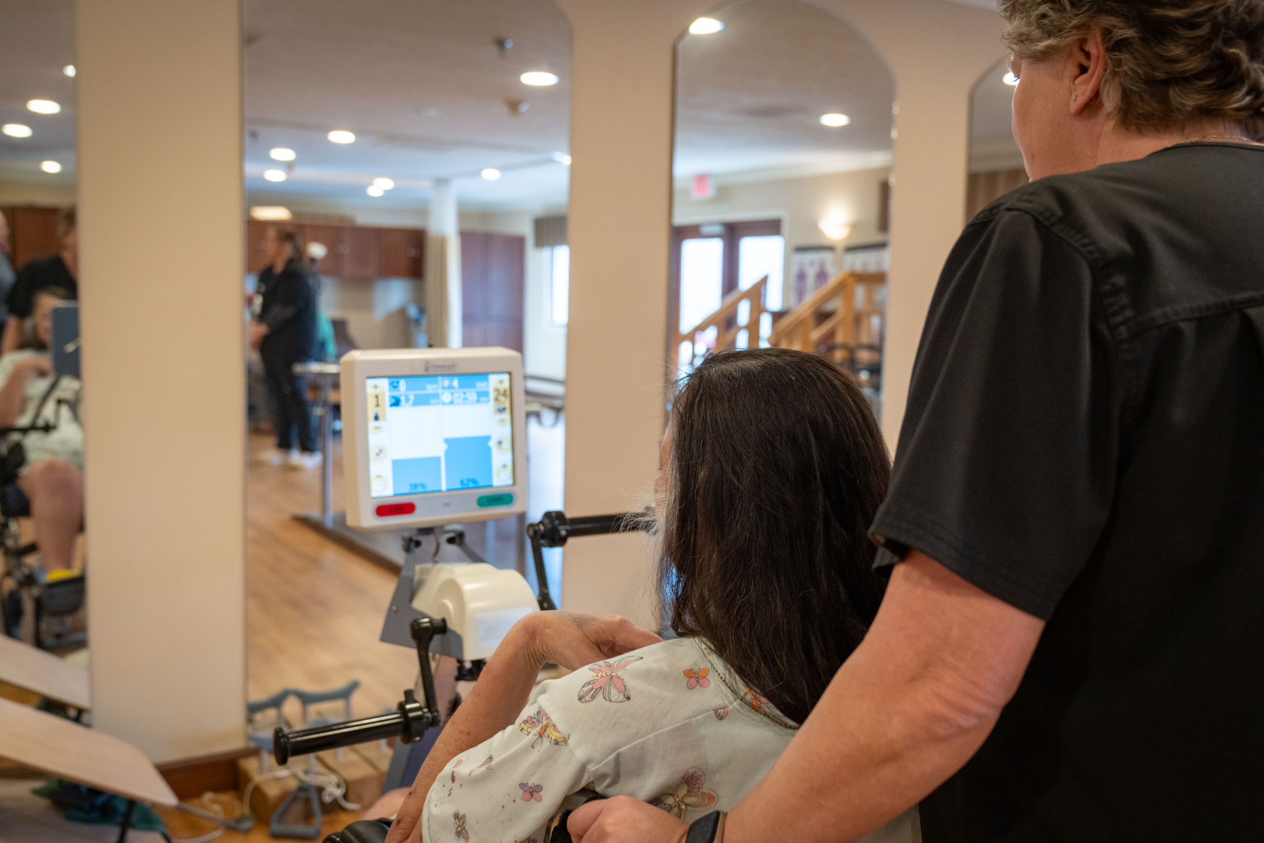 Staff assisting a resident with rehabilitation activities