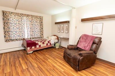 Brightly decorated resident room with floral curtains