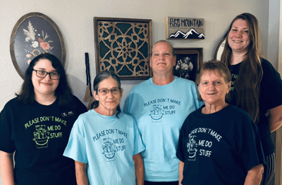 Staff and residents smiling together in a common area
