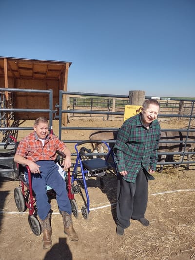 Residents enjoying time outdoors with wheelchairs