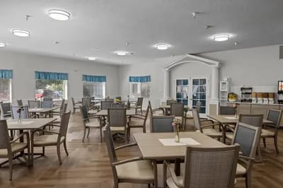 Bright dining room with tables and chairs set for meals
