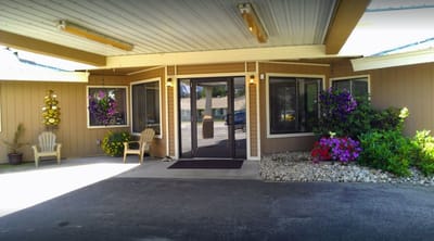 Entrance of the facility surrounded by flowers