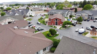 Aerial view of a senior living community with green spaces