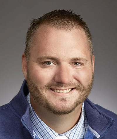 Professional headshot of a man smiling