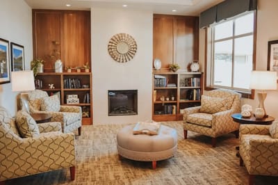A cozy common area with comfortable seating and a fireplace