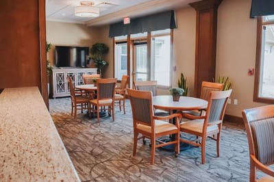 Common area with tables and chairs for residents