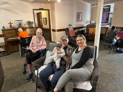Residents and staff engaging in a cozy common area