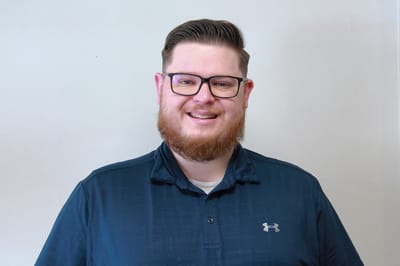 Staff member smiling in a casual setting
