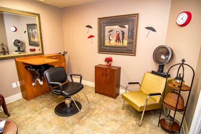 Hair salon area with styling chair and decorations